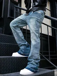 Close-up of vintage washed gray paint-splattered jeans for men with curved-leg design