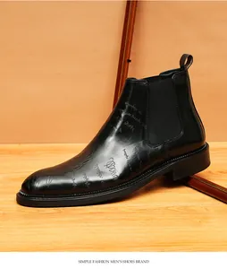 Detailed view of black leather Chelsea boot with a decorative script pattern on the upper