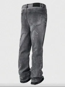 Detailed back view of retro grey washed distressed jeans with white paint splatters