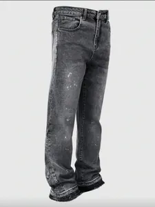 Washed grey distressed baggy jeans with paint splatter and vintage curved leg design