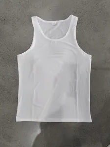Macro view of a white quick-dry athletic tank top for men, showing fabric texture and cut