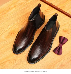 Top-down view of vintage brown leather Chelsea boots with elegant engraved detailing