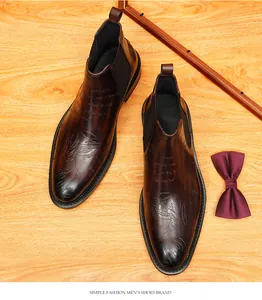 Detail of vintage brown leather Chelsea boots for men with unique engraved script