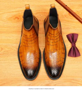 Top view of vintage tan leather Chelsea boots with ornate decorative engravings