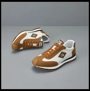 Zijaanzicht van trendy bruin-witte leren herensneakers met een gekartelde rubberen zool.