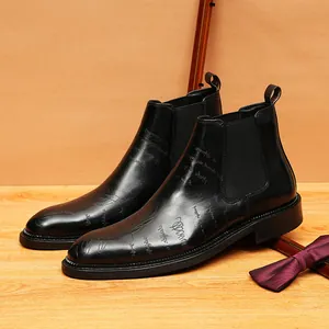 Classic men's black leather Chelsea boots with vintage script engraving detail.