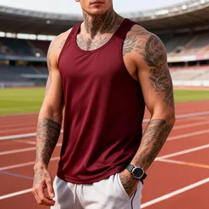 Detail view of a maroon slim-fit quick-dry sports tank top on a muscular male model outdoors