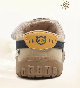 Detailed rear view of beige toddler walking shoes featuring a cute panda icon on the heel.