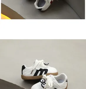 Close-up of baby walking shoes featuring cartoon eyes and a soft gum sole