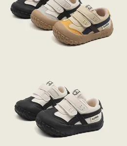 Detailed close-up of bicolor toddler walking shoes with cute panda logo and velcro