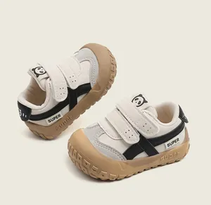 Detailed close-up of kids walking sneakers with panda motif and velcro straps