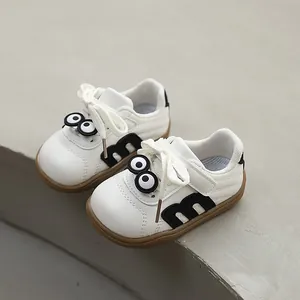 White toddler walking shoes with soft non-slip soles and cute cartoon eye design