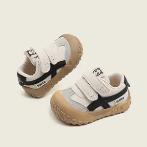 Modern beige toddler walking sneakers with soft soles and a cute cartoon panda logo