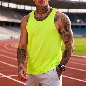 Detail shot of neon yellow men's quick-dry sports tank top on an athletics track