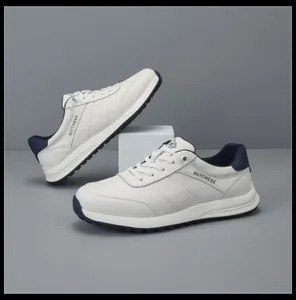 White leather sports casual men's sneakers with navy blue accents on gray background