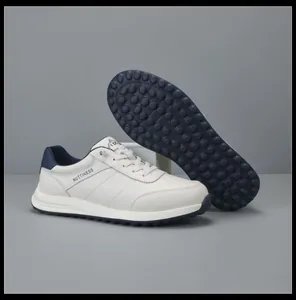 Close-up of white genuine leather men's sneakers showing the detailed non-slip rubber sole