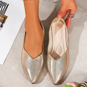 Detailed close-up showing the metallic gold finish of these elegant pointed-toe ballet flats