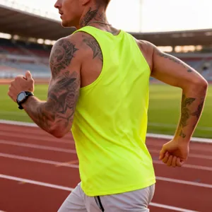 Detail view of neon yellow quick-dry men's running tank top on athletic stadium track