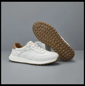 Detailed view of men's white leather sneakers showing the unique brown textured rubber sole