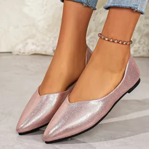 Detail showing pink glitter texture and V-cut design of women's pointed-toe flats