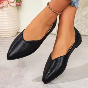 Elegant black pointed-toe ballet flats with V-cut design shown on a model for casual wear.