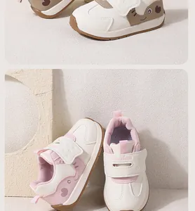 Detailed macro shot of cute cartoon infant sneakers with pink hearts and velcro straps