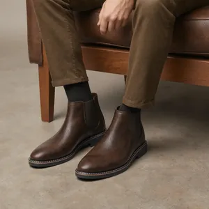 Macro detail view of vintage brown men's Chelsea boots featuring a distressed leather texture