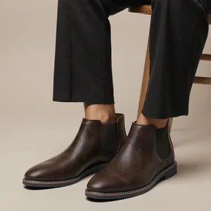 Detailed close-up view of men's retro brown Chelsea boots with brushed leather finish