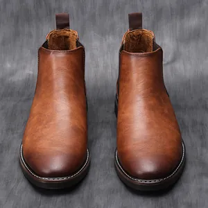 Detailed view of vintage brown Chelsea boots with distressed leather finish and stitching