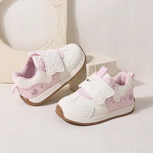 Cute pink and white toddler walking shoes with cartoon heart pattern and velcro strap