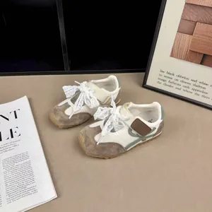 Toddler retro mesh sneakers with grey suede overlays and decorative lace-up ties