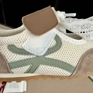 Detailed view of kids breathable mesh sneaker with green accents and suede finish