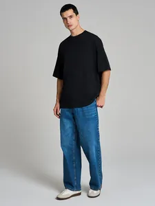 Detailed studio shot of a men's oversized heavyweight black cotton short sleeve T-shirt.