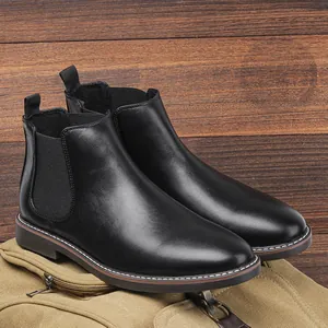 Close-up of classic black leather men's Chelsea boots with elegant white stitching