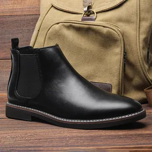 Classic black leather Chelsea boot for men displayed against a rustic vintage background