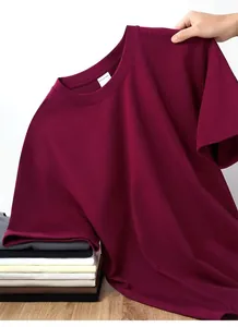 Close-up of heavyweight pure cotton t-shirt collar and a stack of various colors