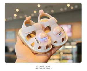 Close-up of pink toddler sandals featuring a cute light-up mushroom design for baby walking.