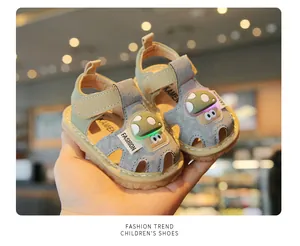 Close-up view of baby sandals with glowing cartoon mushroom detail and soft sole