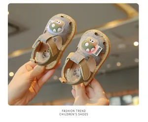 Detailed view of baby squeaky sandals featuring a cartoon dinosaur and LED lights.