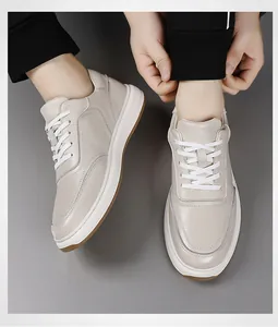 Close-up detail of beige top layer cowhide leather sneakers for men with laces.