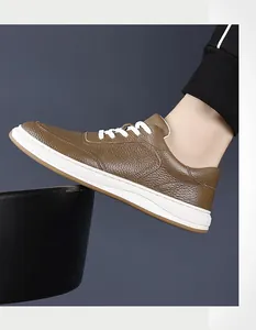 Side view detail of brown textured leather sneaker with white sole and laces