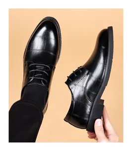 Close-up showing the crocodile embossed leather texture of these black men's dress shoes