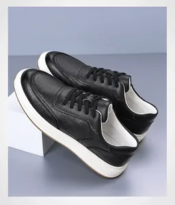 Close-up detail of premium black pebble-grain leather sneakers for men with white soles