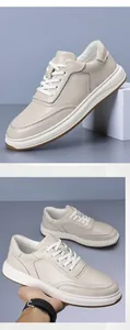 Detailed texture of off-white top grain leather men's sneakers with white soles.