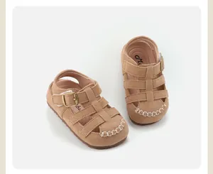 Detailed view of brown retro toddler sandals with hollowed-out design and buckle strap