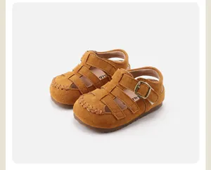 Close-up of children's retro suede Roman sandals with buckle strap and hollow design