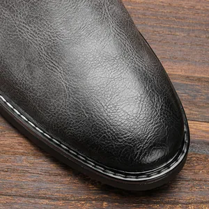 Detailed macro view of black vintage leather Chelsea boot toe with stitching details