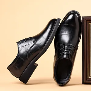 Black men's formal dress shoes featuring embossed crocodile texture and lace-up design
