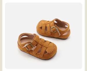 Detailed view of brown suede children's closed-toe Roman sandals with soft soles