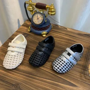 Detail showing woven mesh Mary Jane sandals in white, black and silver colors.